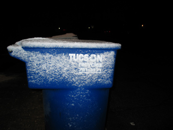 'Tucson' is readable under the snow on this recycling bin.