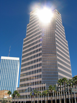 A tall building reflects the sun in this picture.